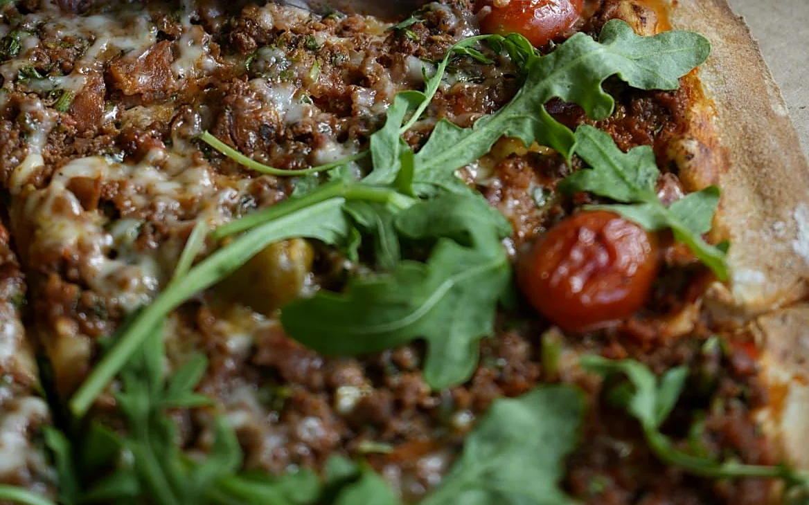 Kafta flatbread with arugula and grape tomatoes